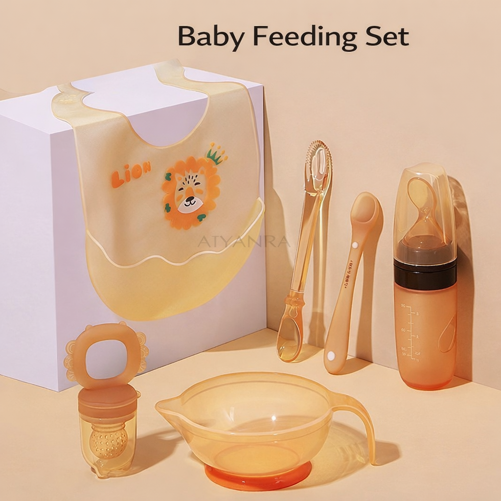 Baby feeding set with bib, bottle, and other items on a beige background