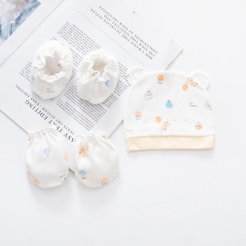 Baby hat and booties with colorful patterns on a magazine page