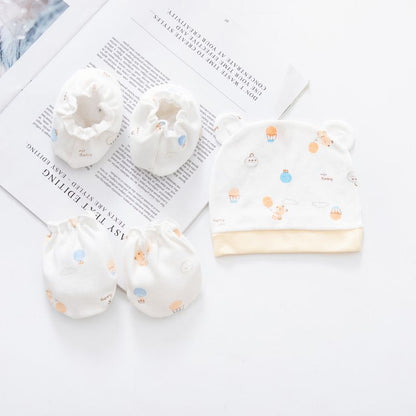 Baby hat and booties with colorful patterns on a magazine page